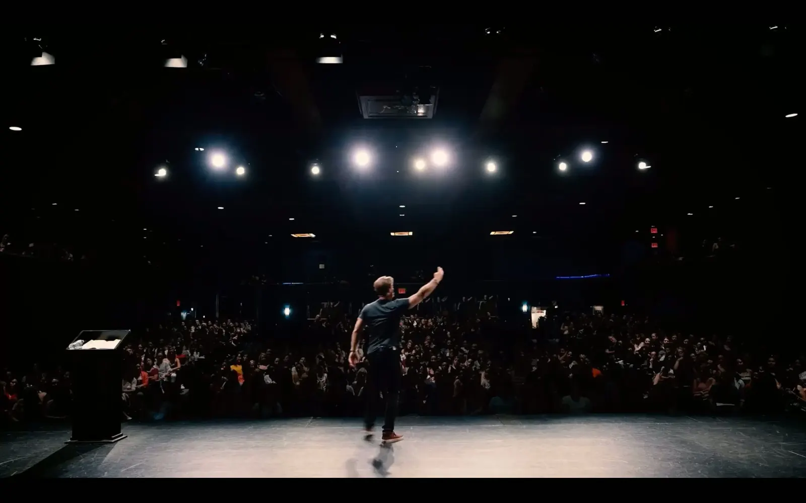 Matthew Hussey on stage speaking to a packed live audience